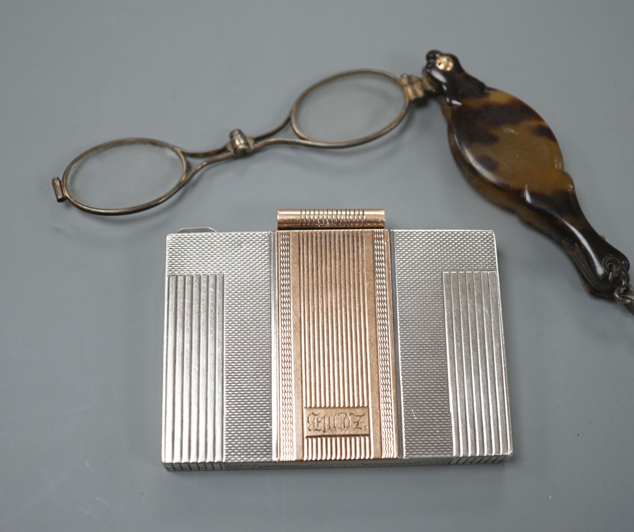 A white and yellow metal (stamped silver 9ct) compact and a pair of tortoiseshell mounted spectacles.